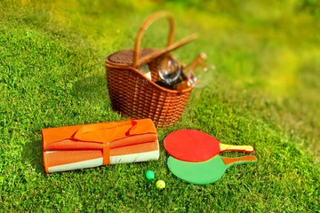 Keuken spatwand met foto Picnic basket,  blanket,  racquetball in the grass © Alex