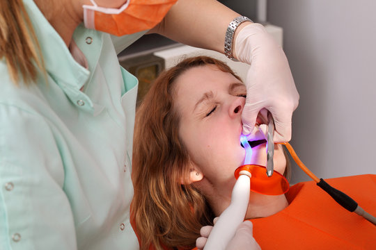 Dentist using dental UV curing light led laser dental procedure