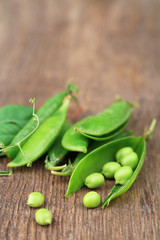 Fresh green peas on wooden table