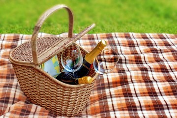 Picnic blanket and basket in the grass
