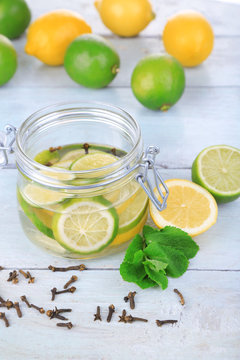 Pickled limes and cloves in glass jar,