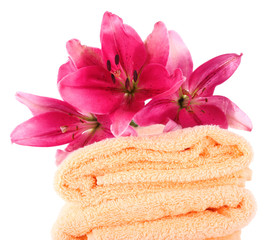 Color towels and lily flowers, isolated on white