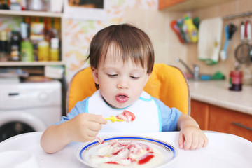 lovely baby eating semolina porridge