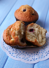 Blueberry muffins on color wooden background
