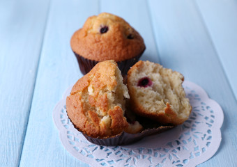 Blueberry muffins on color wooden background