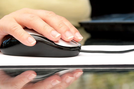 Woman hand using computer mouse