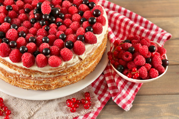 Tasty cake with fresh berries on wooden table