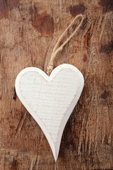 white wooden heart on old wooden background © Elena Moiseeva