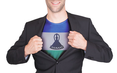 Businessman opening suit to reveal shirt with flag