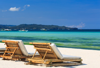 Beach chairs on tropical white sand beach