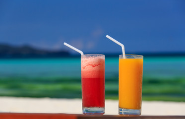 mango and watermelon cocktails on tropical beach