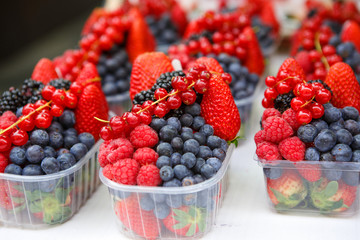 basket with fresh juicy berries on farmer market