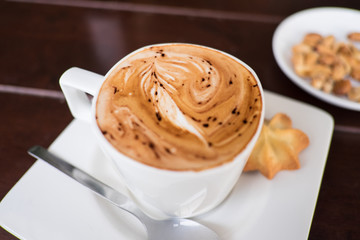 Coffee cup and cookie