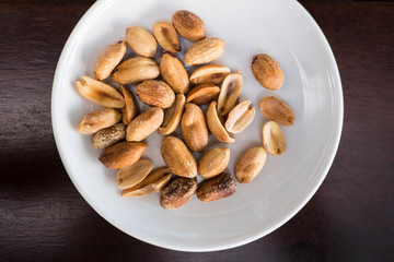 Salt roasted peanut in white plate