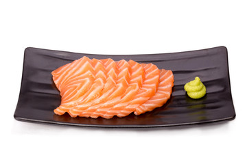 Cut raw salmon fat (salmon sashimi) on plate isolated on white