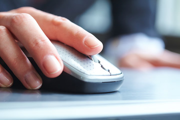 female hand clicking computer mouse