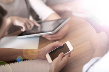 Group of business people using electronic devices at work