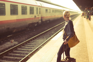 Lady waiting at the railway station.