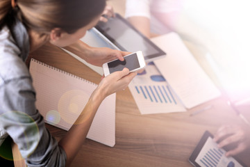 Group of business people using electronic devices at work