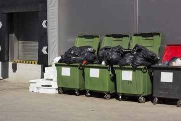 Green garbage containers  near large food shop