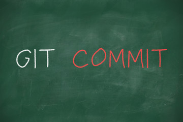 Obraz premium Git commit handwritten on blackboard