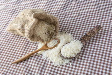 Obraz premium rice in small burlap sack isolated on table
