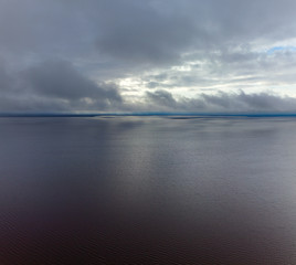 Aerial view from above large lake in overcast weather