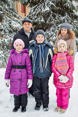 Family of five stands outside in winter