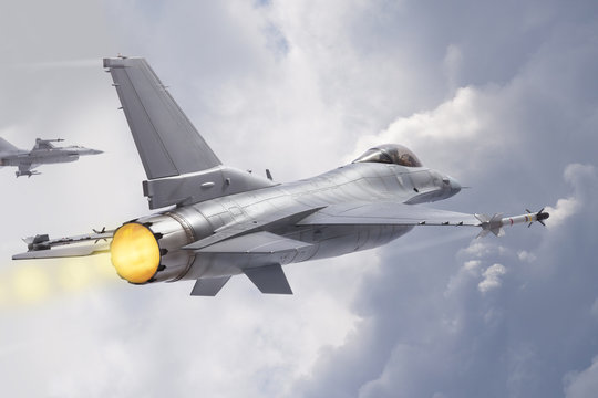 F-16 Fighting Falcon jets (models) fly through clouds