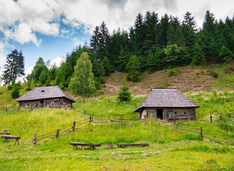 Fototapeta na wymiar Old wooden houses and mountains