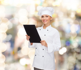 smiling female chef with black blank paper