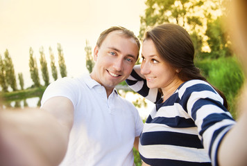 Fototapeta premium Pregnant couple taking selfie