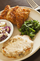 Vegan fried chicken substitute served with slaw, mashed potatoes