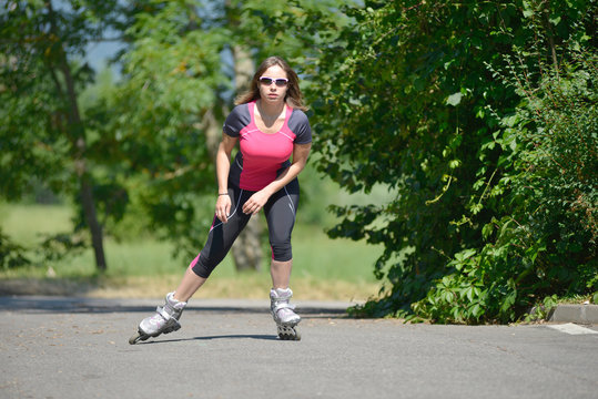 pretty young woman doing rollerskate on a track
