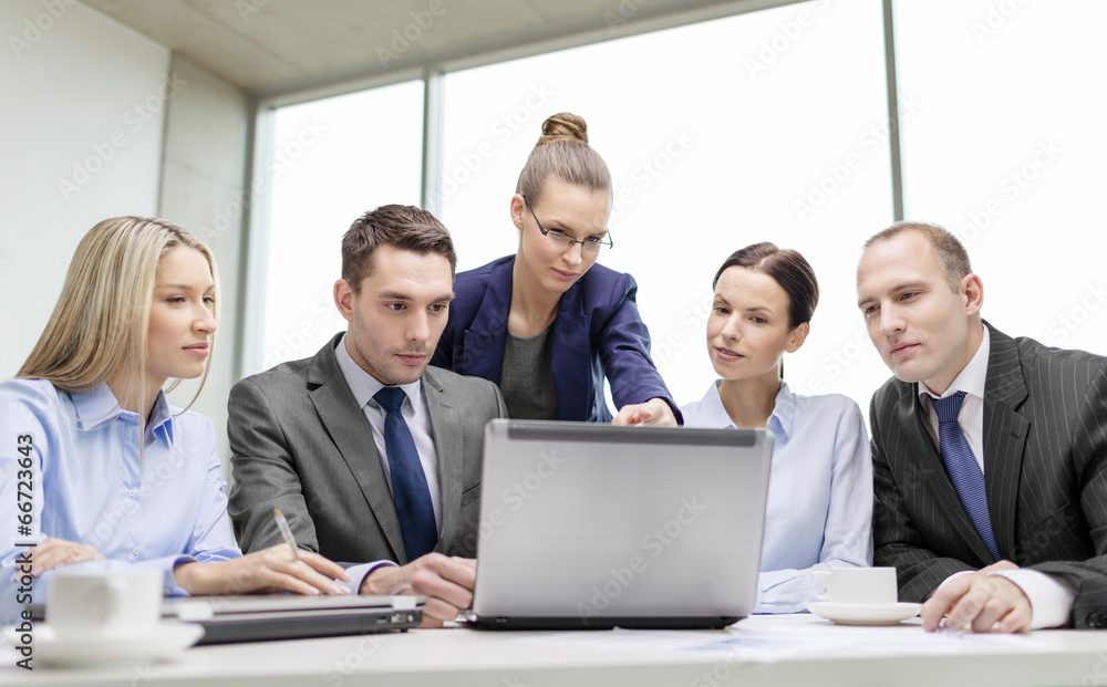 Wall mural business team with laptop having discussion