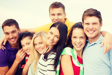 group of friends having fun on the beach