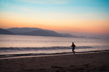Fototapeta na wymiar Man running on the beach