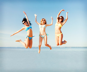 girls jumping on the beach