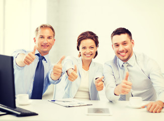 business team showing thumbs up in office