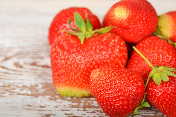 Some red strawberry on wooden background, DOF