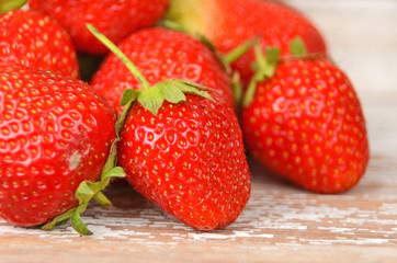 Some red strawberry on wooden background, DOF