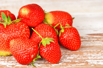 Some red strawberry on wooden background, DOF