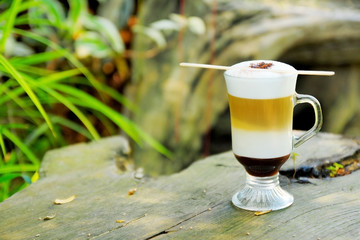 hot caramel macchiato coffee in folk garden