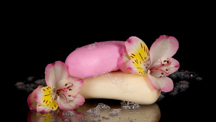 Wet pieces of soap with flower the alstroemeria