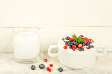oatmeal with blueberries and strawberries in the white bowl
