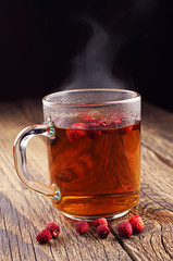 Cup of hot tea with wild strawberries