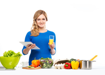 Young and beautiful housewife woman cooking in a kitchen