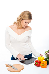 Young and beautiful housewife woman cooking in a kitchen