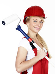 Woman with paint roller is renovating