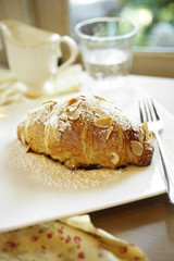 close up croissant on white dish in coffee shop